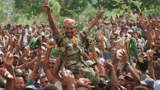 Crowds celebrate after PM Julius Chan announces he will step down, days after the mercenary crisis came to a head.