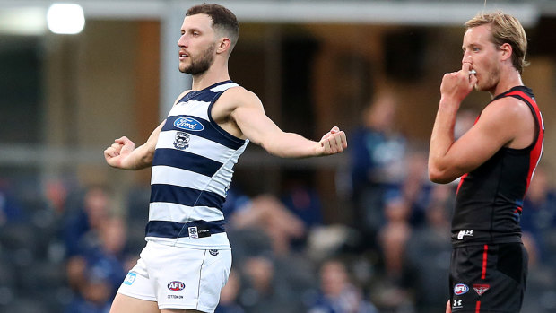 Romping home: Sam Menegola stretches Geelong's lead during their impressive win over Essendon.