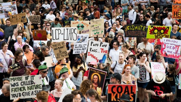 Climate change protesters rally against Scott Morrison's response to the bushfire crisis in Sydney on Friday.