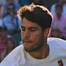 Defending two-time Wimbledon champion Carlos Alcaraz slides to return serve against Cameron Norrie.