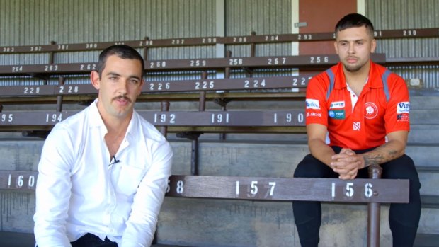 Taylor Walker alongside Robbie Young in an awkward apology video.