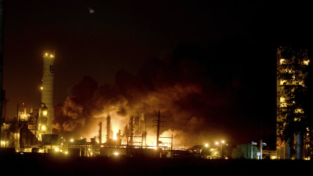 Flames and thick black smoke light up the pre-dawn sky following and explosion at the TPC plant in Port Neches, Texas. 