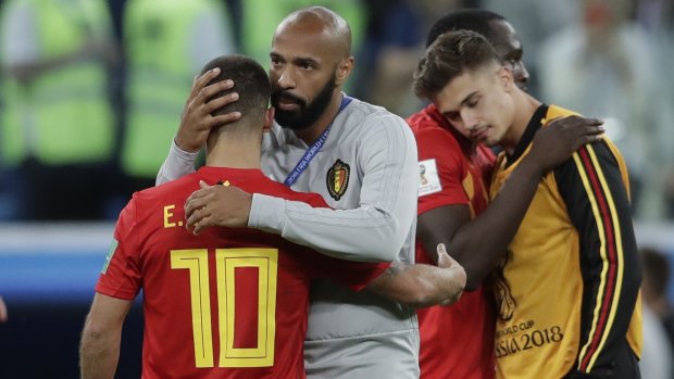 Belgium assistant Henry consoles Eden Hazard after Belgium's semi-final loss at the Cup.