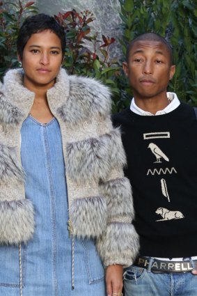Pharrell Williams and his wife Helen Lasichanh at the 2019 Paris Fashion Week. He may be happy, but he is not a fan of the nappy change.