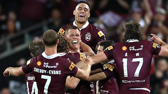 Lindsay Collins and his Maroons teammates celebrate the final try in Adelaide.