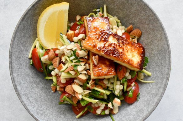 Simple ingredients star in this salad, which tops pearl couscous, zucchini and almonds with golden halloumi.