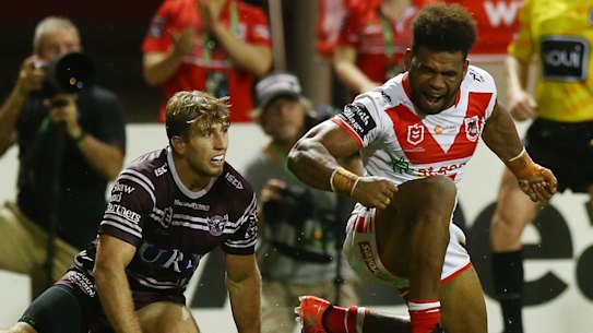 Unstoppable: Mikaele Ravalawa storms across the line for the Dragons.