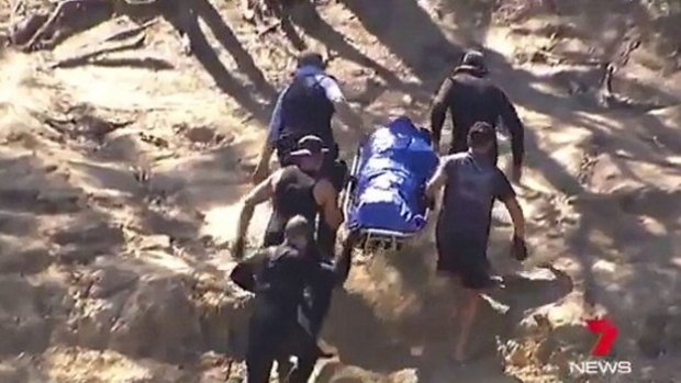 The body of the five-year-old is taken from the river, days after he was drowned by his mother. 