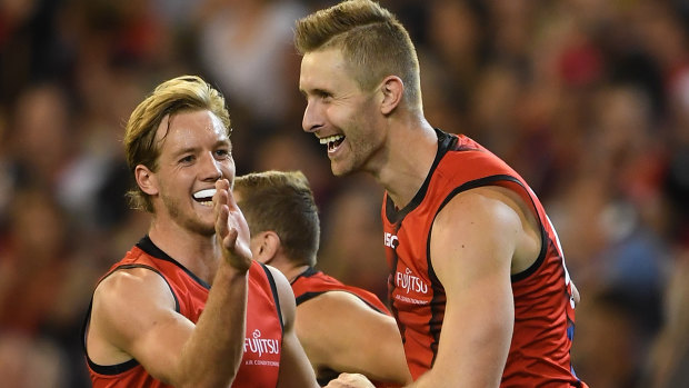 Winning grins: Darcy Parish (left) and Shaun McKernan celebrate after extending the Bombers' lead over the Demons.