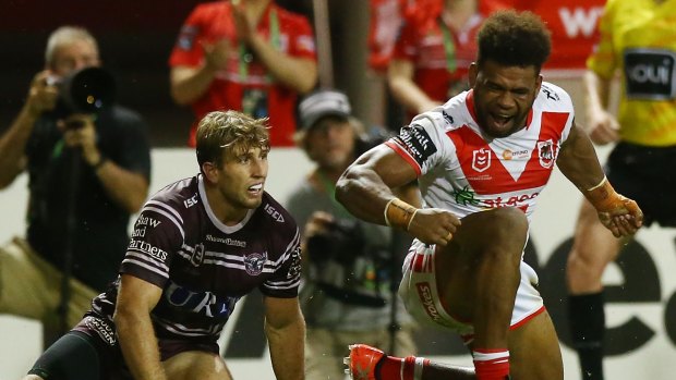 Unstoppable: Mikaele Ravalawa storms across the line for the Dragons.