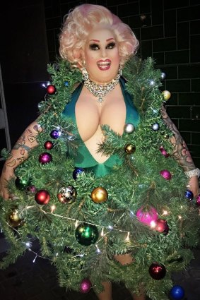 Maxi Shield suffers for her art in a Christmas tree dress.