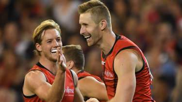 Winning grins: Darcy Parish (left) and Shaun McKernan celebrate after extending the Bombers' lead over the Demons.