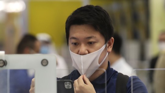 A Japanese journalist checks out the new face and iris-recognition procedures, during a media tour at Dubai airport, United Arab Emirates. 