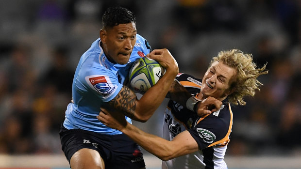 Israel Folau of the Waratahs (left) is tackled by Joe Powell of the Brumbies. 