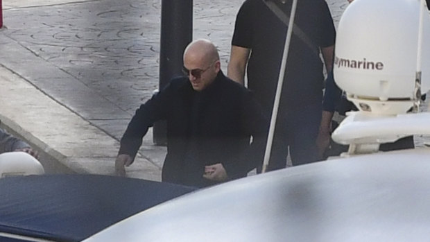 Maltese businessman Yorgen Fenech is accompanied by police during a search of his yacht in Malta.