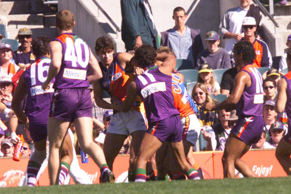 Players wrestle during the “demolition derby”.