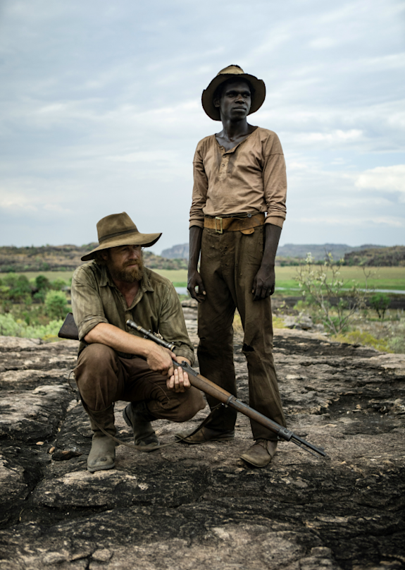 Simon Baker as Travis and Jacob Junior Nayinggul as Gutjuk in High Ground.
