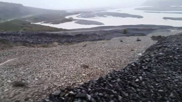 The shingle river sounded like when a "gravel truck tips all its load". 