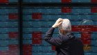 A person looks at an electronic stock board showing Japan’s Nikkei 225 index at a securities firm.
