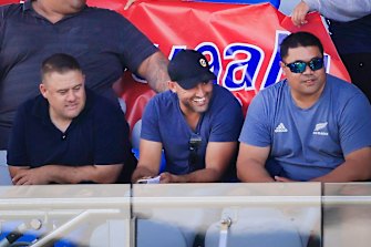 Deregistered player agent Isaac Moses (in blue shirt and black cap) sitting with the Suaalii family on Saturday.