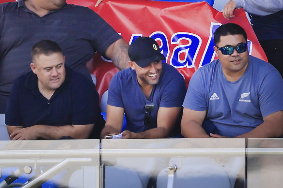 Deregistered player agent Isaac Moses (in blue shirt and black cap) sitting with the Suaalii family on Saturday.