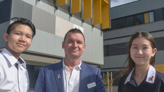 Homestead students Amelia Blake and Hayden Chan with founding school principal Michael Fawcett at the school grounds in Point Cook.