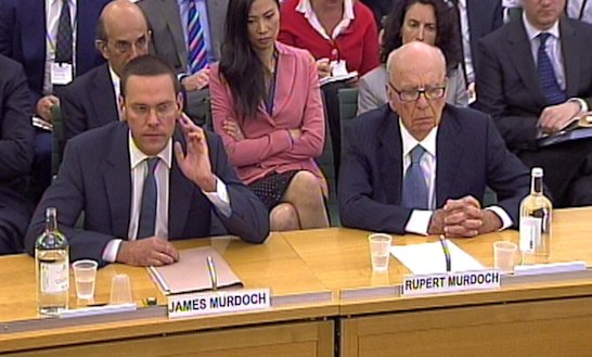 James Murdoch, pictured giving evidence with his father Rupert before the UK's Culture, Media and Sport Select Committee, survived fallout from the News of the World phone-hacking scandal.