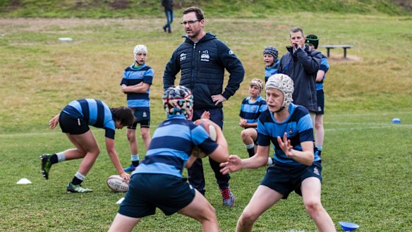 Brumbies head coach Dan Mackellar trains with the the Canberra Grammar under-14s team last year.