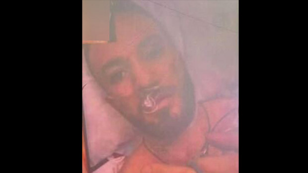 A screenshot of Suleiman “Sam” Abdulrahim flipping the bird at his attackers from his hospital bed.