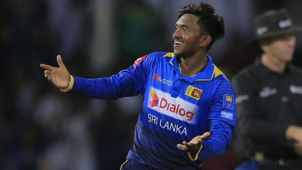 Sri Lanka's Akila Dananjaya gestures towards spectators as he celebrates after taking the wicket of South Africa's Andile Phehlukwayo.