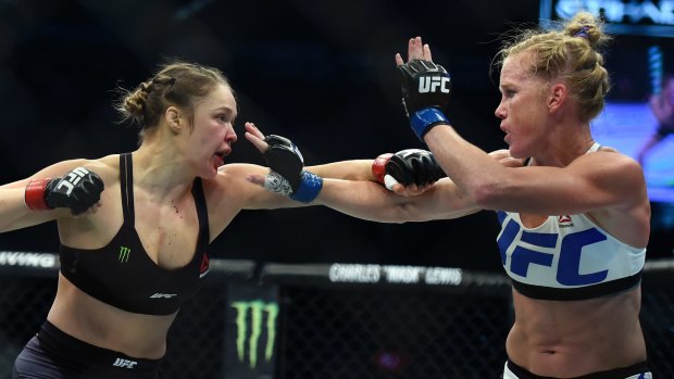 Ronda Rousey (left) fights Holly Holm (right) in the 2015 UFC 193.