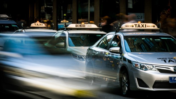 Taxi cabs queue at a rank in Sydney's CBD.