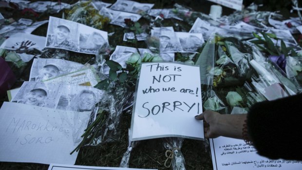 Moroccans lay flowers and messages during a candlelight vigil in Rabat.