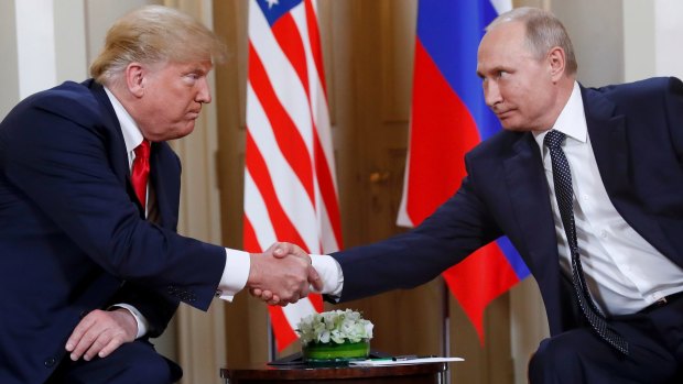 US President Donald Trump and Russian President Vladimir Putin shake hands at the beginning of a meeting at the Presidential Palace in Helsinki in July.