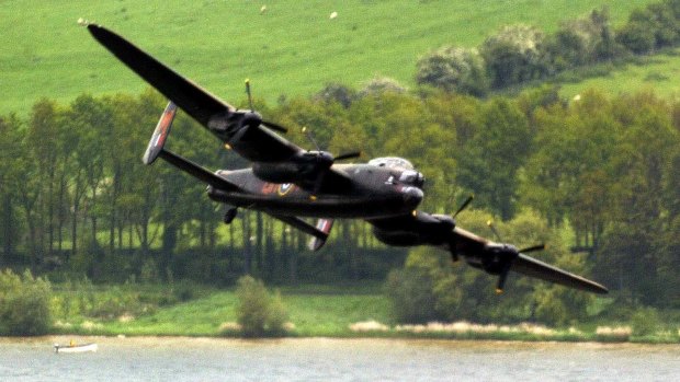 A Lancaster bomber swoops over Eyebrook Reservoir in central England, May 17, 2003. to mark the 60th anniversary of the Dambuster raid.  