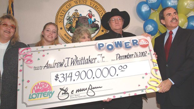  Andrew "Jack" Whittaker, jnr (black hat) with a cheque for $314.9 million won in a Christmas Day jackpot in 2002.
