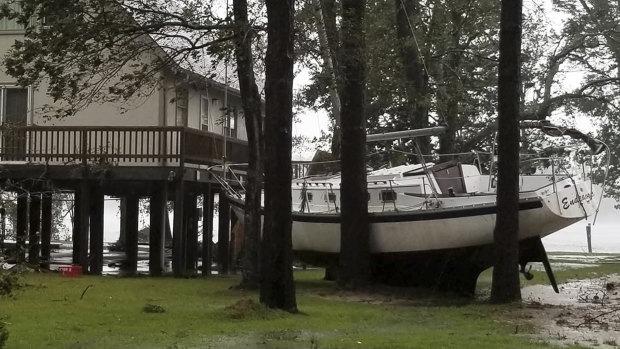 A boat became wedged in trees in Oriental, North Carolina on Friday.