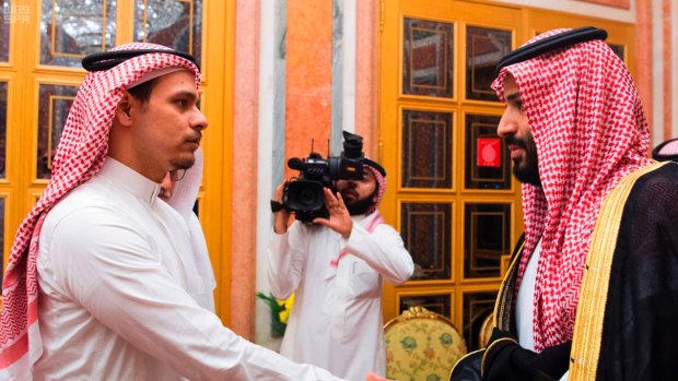 Saudi Crown Prince Mohammed bin Salman, right, shakes hands with Salah Khashoggi, son of Jamal Khashoggi.