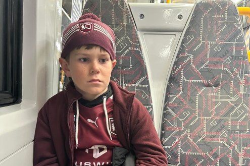 A devastated 11-year-old Carter McPherson on the train home from Suncorp Stadium.