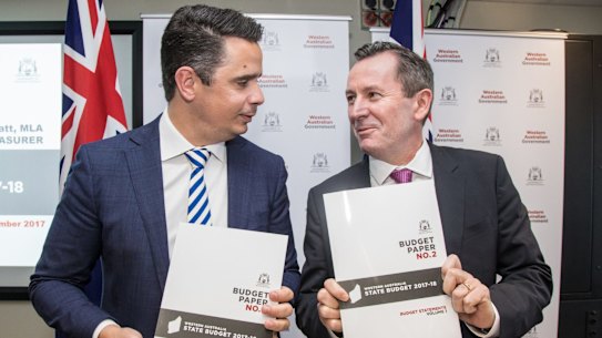Western Australia Treasurer Ben Wyatt and Premier Mark McGowan open the state budget papers in front of the media prior to announcing the budget in parliament on Thursday,