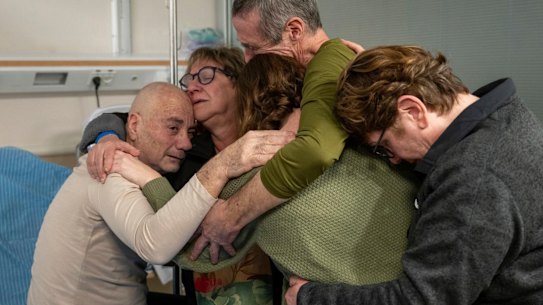 Hostage Luis Har (left) is hugged by relatives after being rescued.