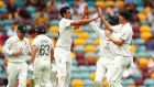 BRISBANE, AUSTRALIA - DECEMBER 08: Mitchell Starc of Australia celebrates dismissing Jos Buttler of England during day one of the First Test Match in the Ashes series between Australia and England at The Gabba on December 08, 2021 in Brisbane, Australia. (Photo by Chris Hyde/Getty Images)