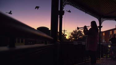 Sarah Brown plays The Last Post from the balcony of The Royal Hotel in Leichhardt. 