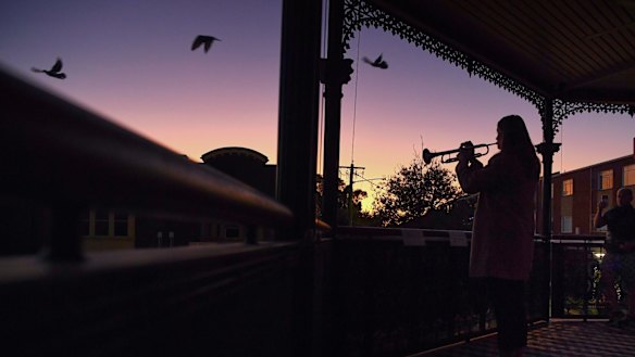 Sarah Brown plays The Last Post from the balcony of The Royal Hotel in Leichhardt. 