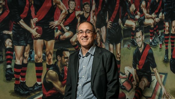 Essendon CEO Craig Vozzo signs personalised and framed certificates for Bombers Forever bequestors.