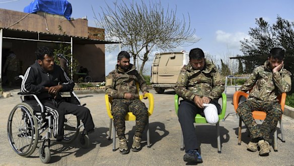 These wounded Kurdish soldiers are helping each other recuperate, but need medical attention.