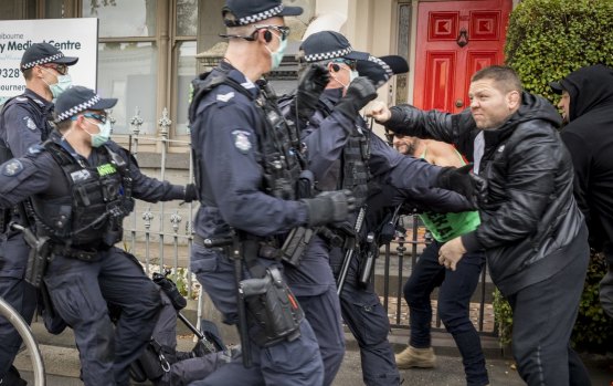 Victoria Police confront protesters in Victoria Street, North Melbourne, on May 29 for breaching lockdown directives. No social distancing there either.