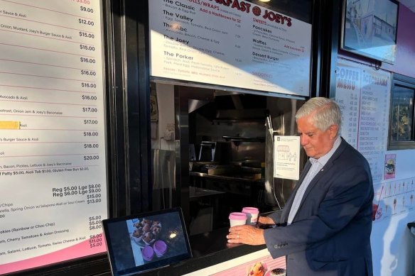 Indigenous Affairs Minister Ken Wyatt grabs a coffee on election day. 