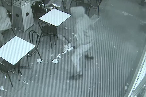 Security footage of one of the alleged offenders brandishing a bladed weapon.