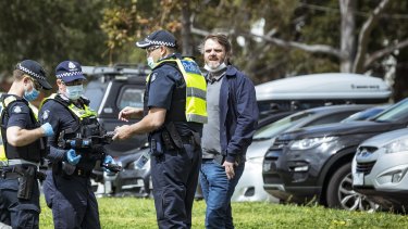 Melbourne actor Damien Richardson is seen speaking to police at a #reclaimtheline anti-lockdown protest in Moonee Ponds.